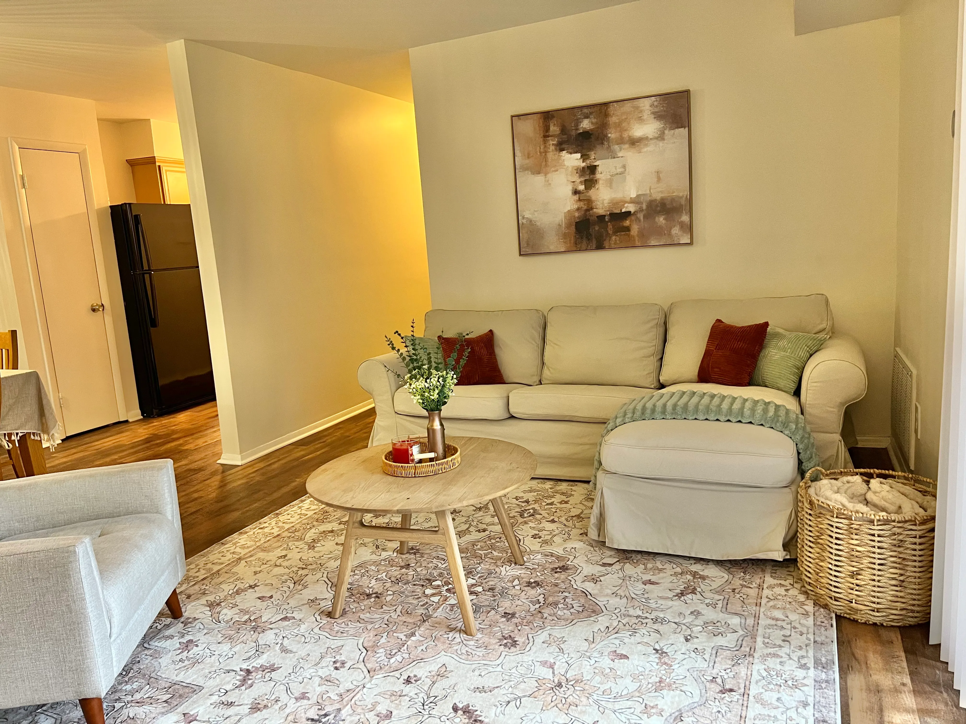 Open living and dining area with warm wood floors and layered textures